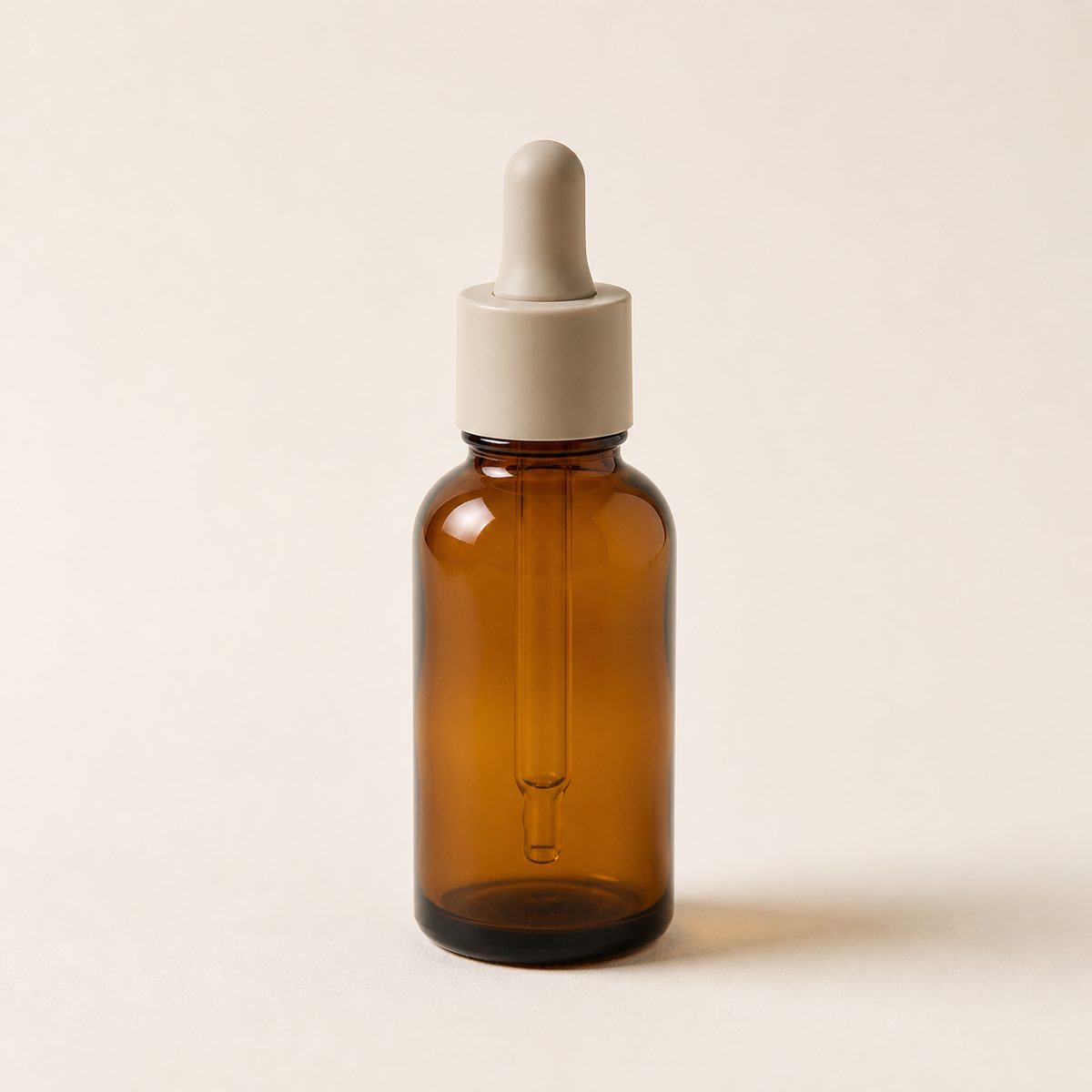 Plain photo of an amber serum bottle on a white background